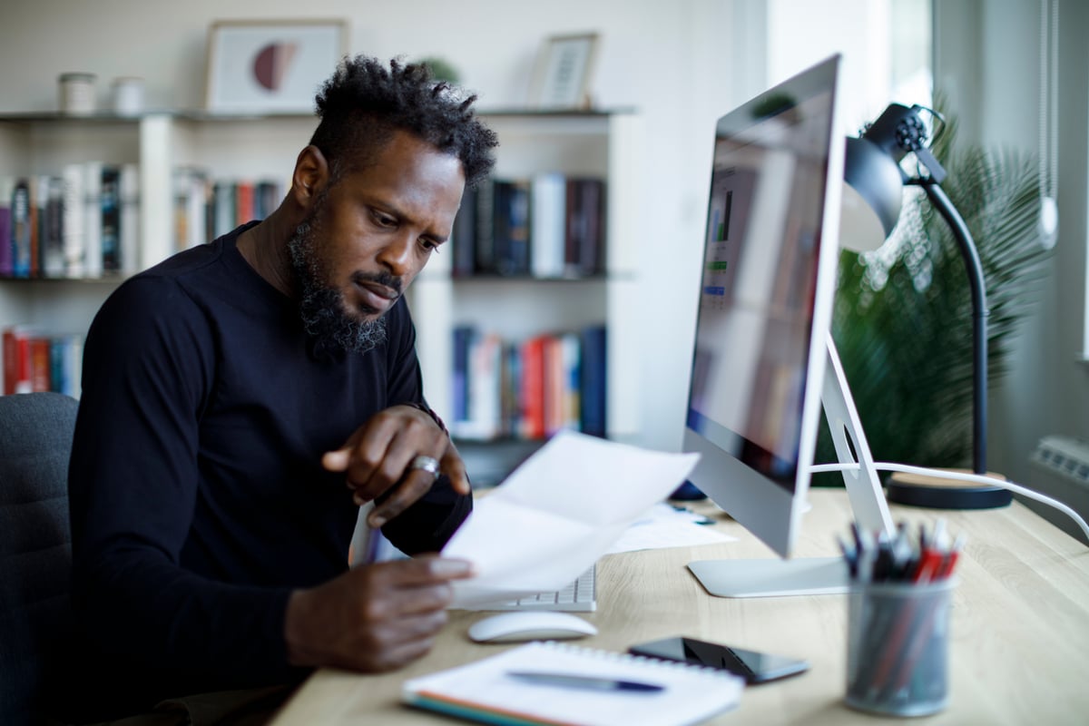 A person in an office looks at a document.