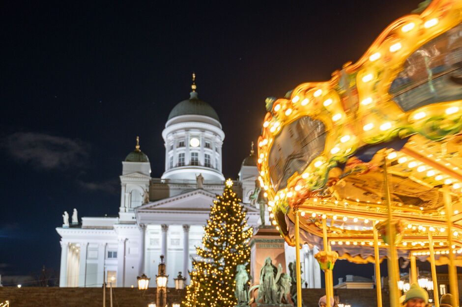 View of moving carousel and Helsinki Cathedral at Christmas market