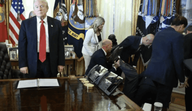 Trump looks on after a man fainted during an announcement in the Oval Office.