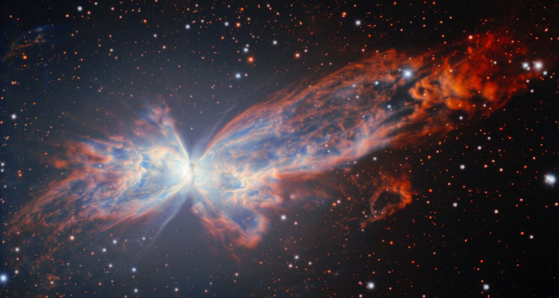 A butterfly shaped nebula of red and white light glows in the darkness of spce