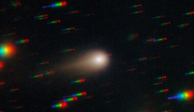 an image of a comet streaking through space with the stars around it reflecting rainbows