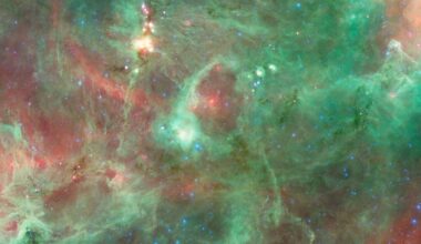 A glowing gas ring in green and red colors in outer space