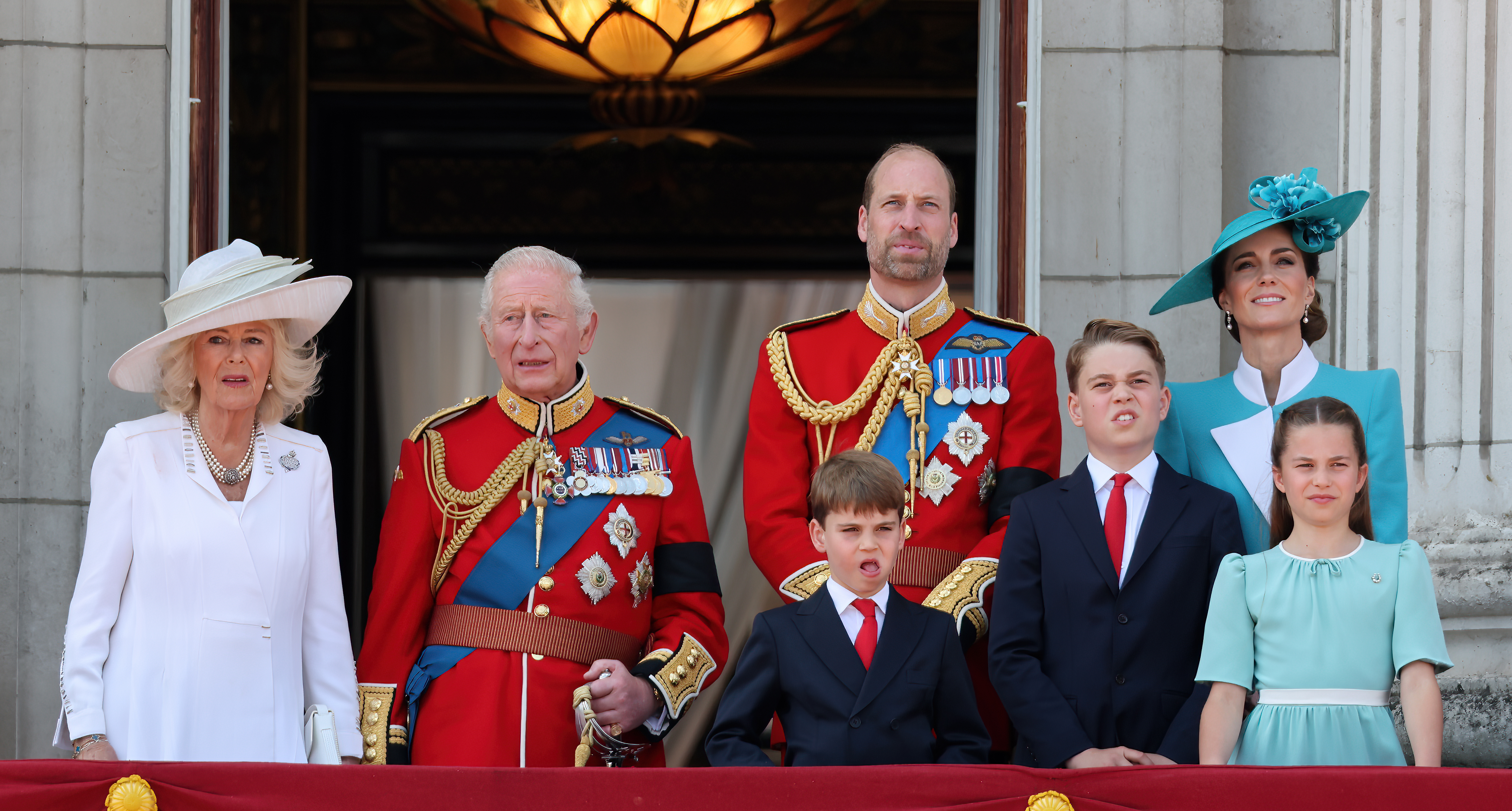 The Royal Family stands on the balcony to watch the flypast at the conclusion of the Trooping of the Colour ceremony marking the King’s birthday.