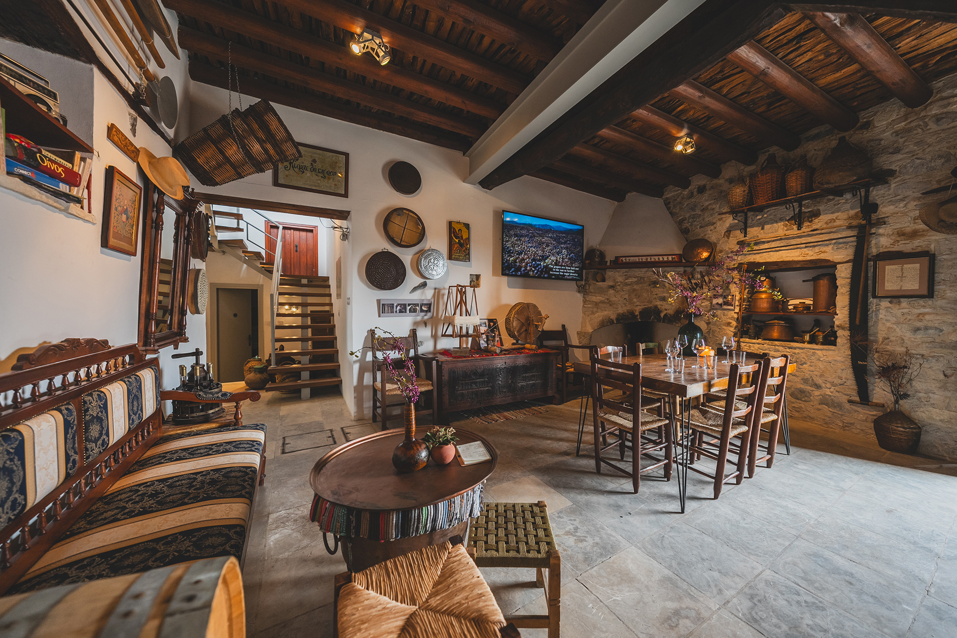Interior of Revecca Winery, near Limassol, with a dining table, seating, and traditional decorations.