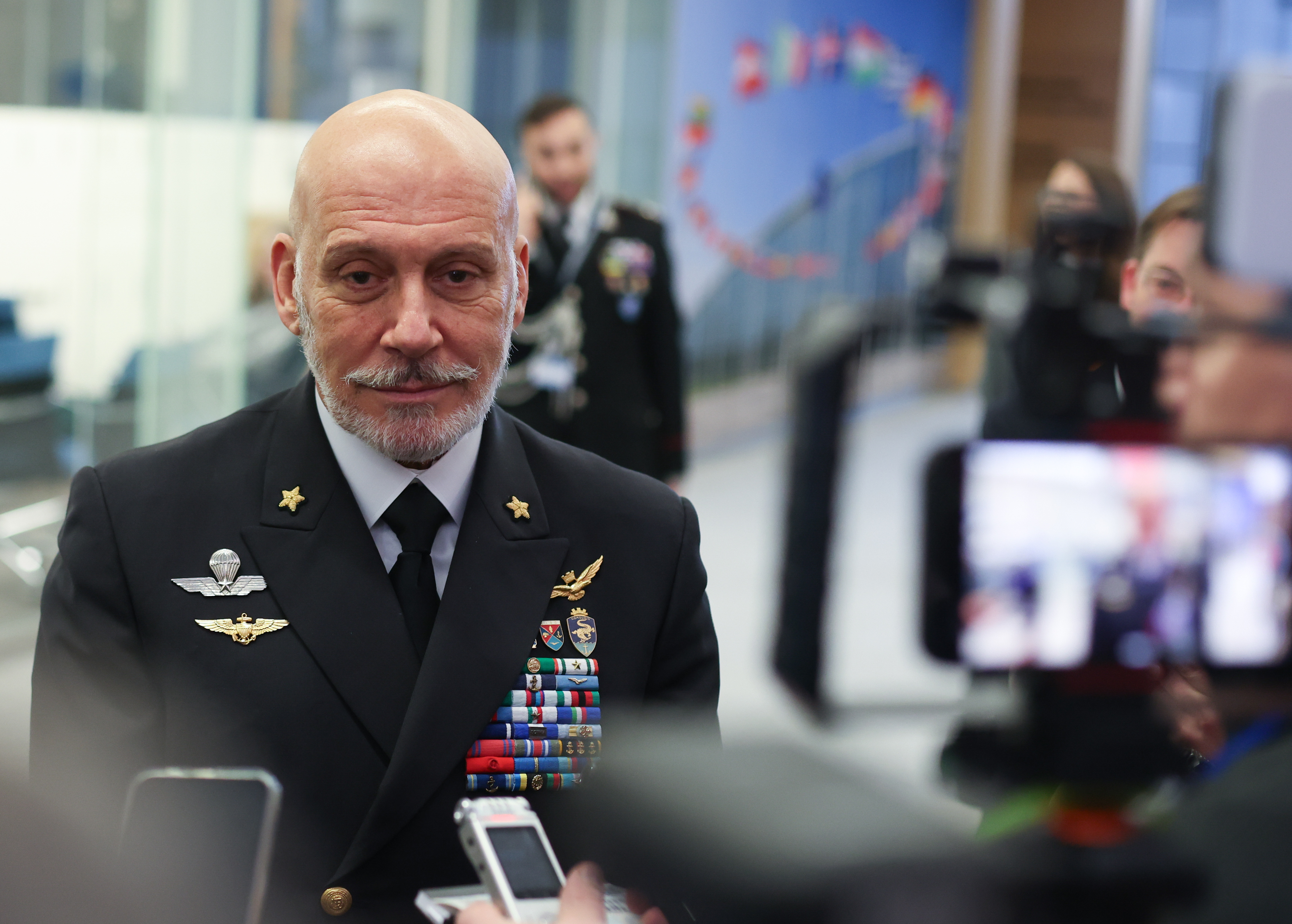 Italian Admiral Giuseppe Cavo Dragone speaking to media at NATO headquarters.