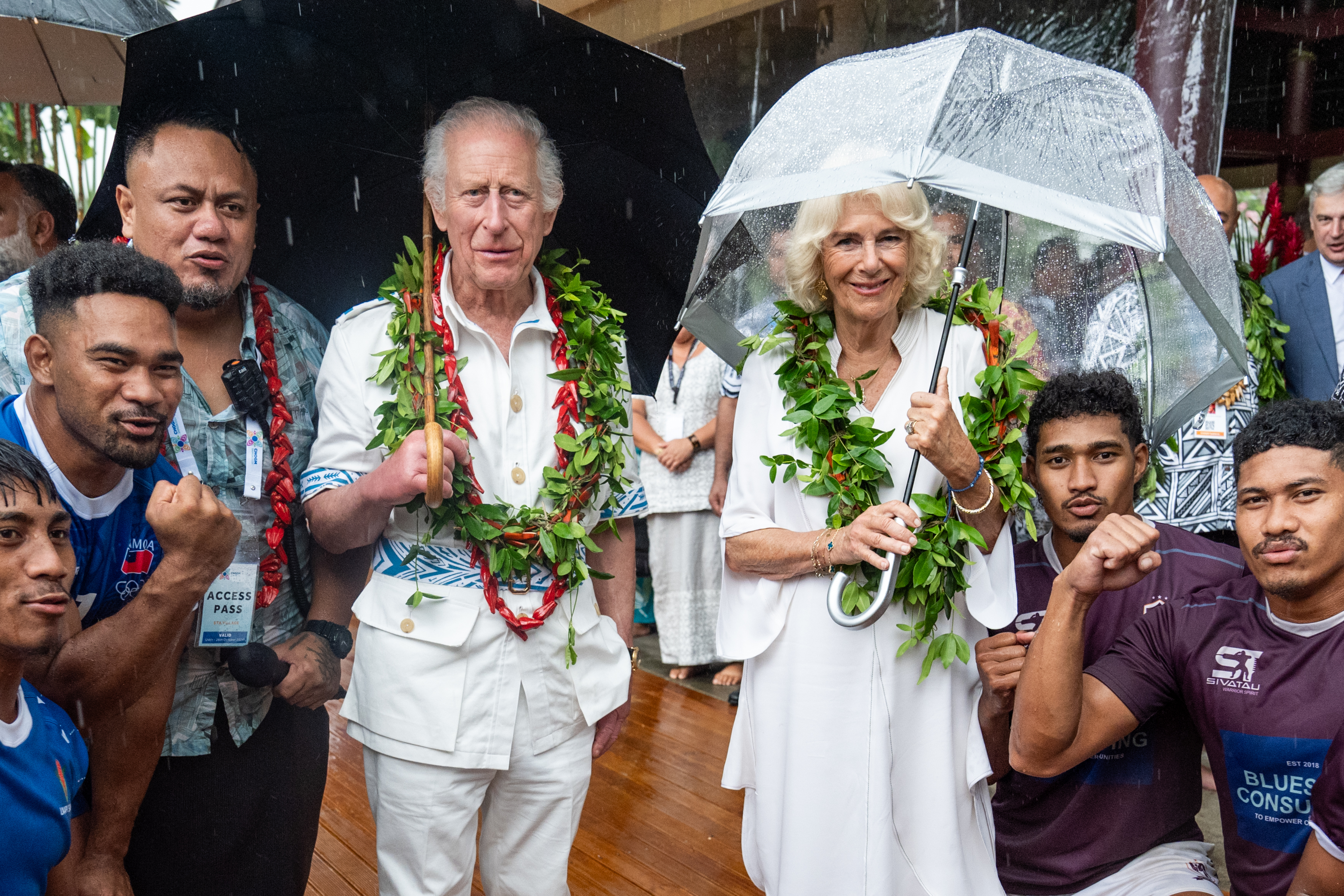 King Charles III and Queen Camilla with members of the Apia rugby team.