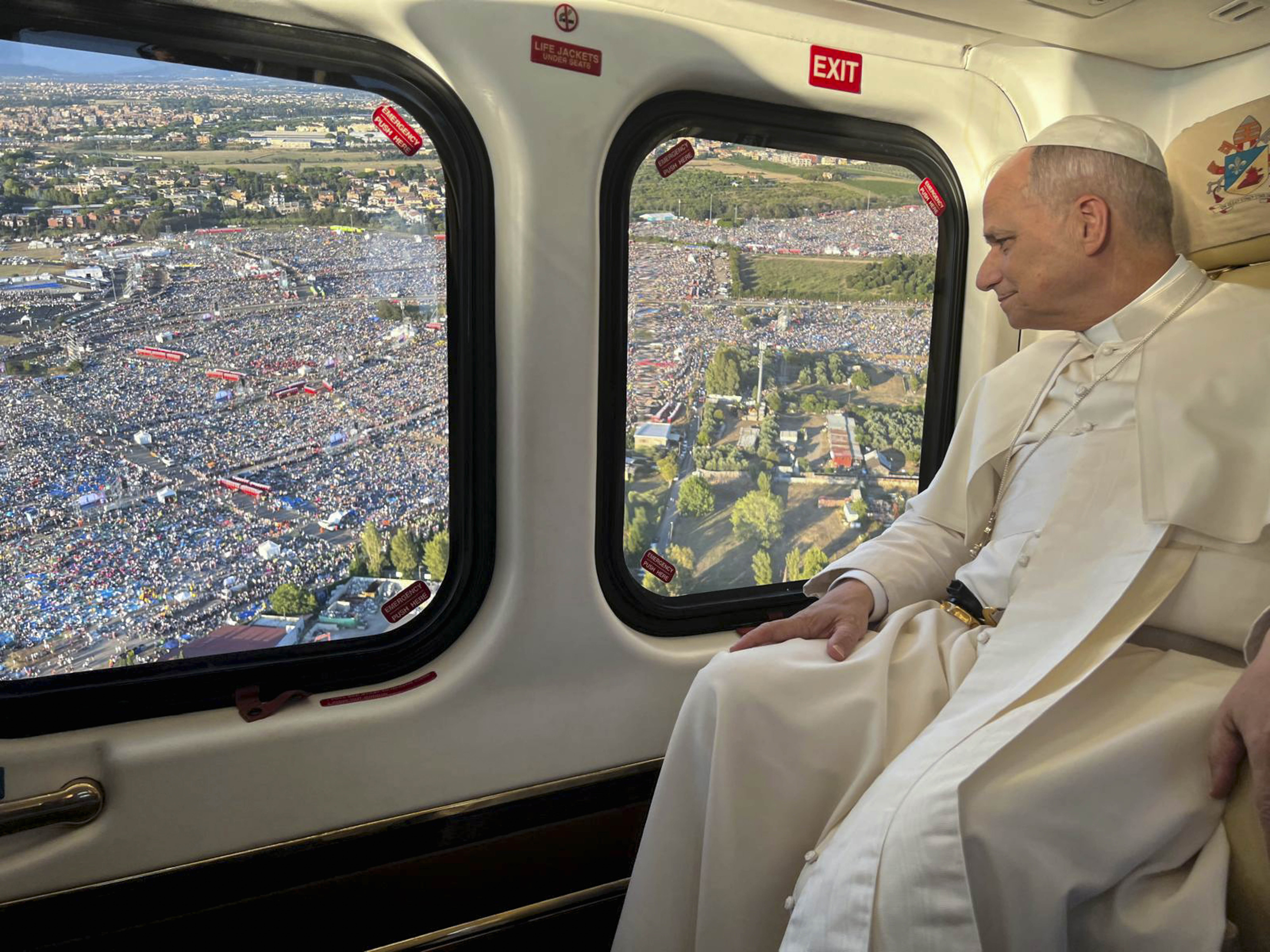 Pope Leo XIV in a helicopter observing crowds of people at the Jubilee of Youth prayer vigil.