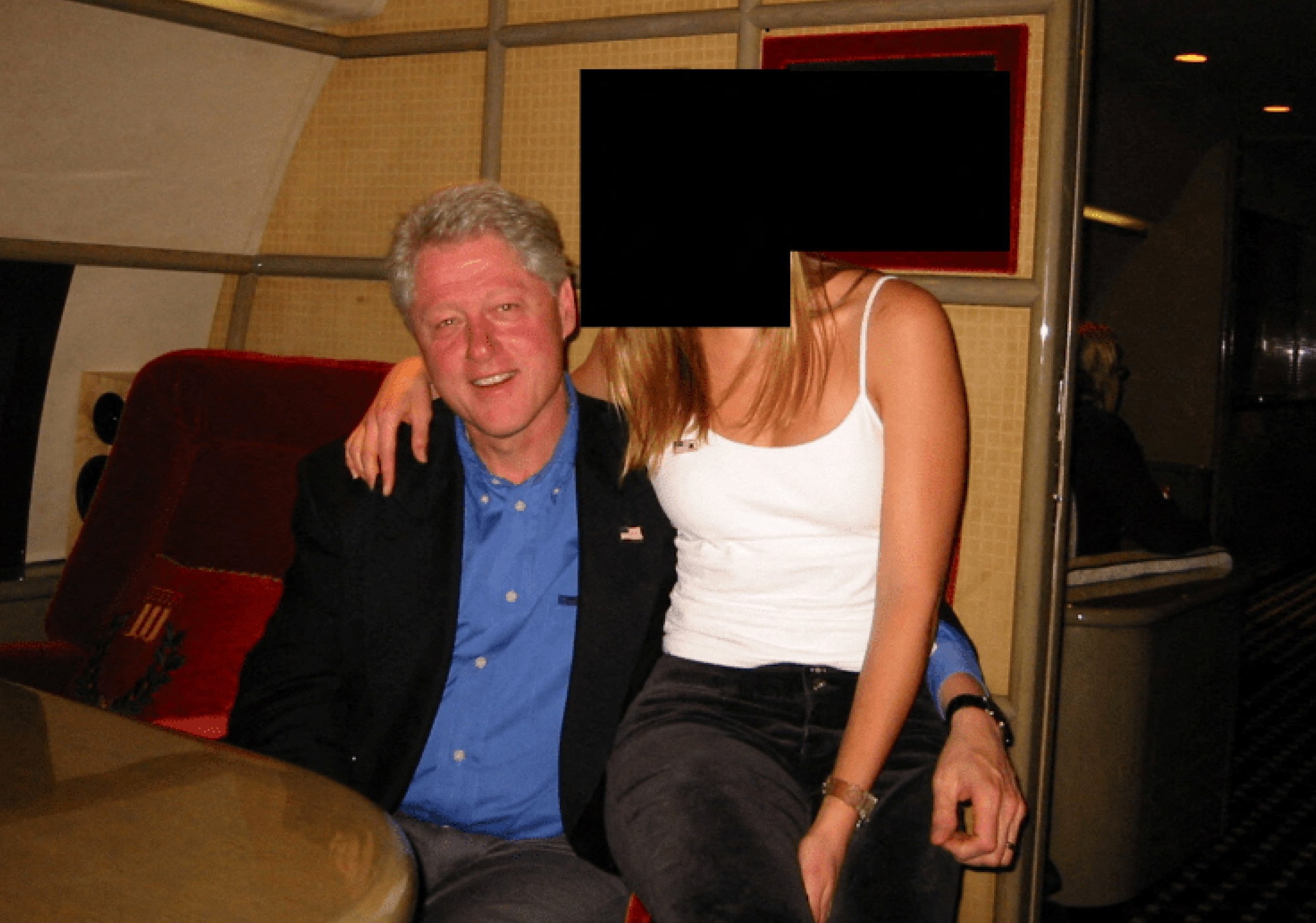Former U.S. President Bill Clinton with a woman whose face is redacted.