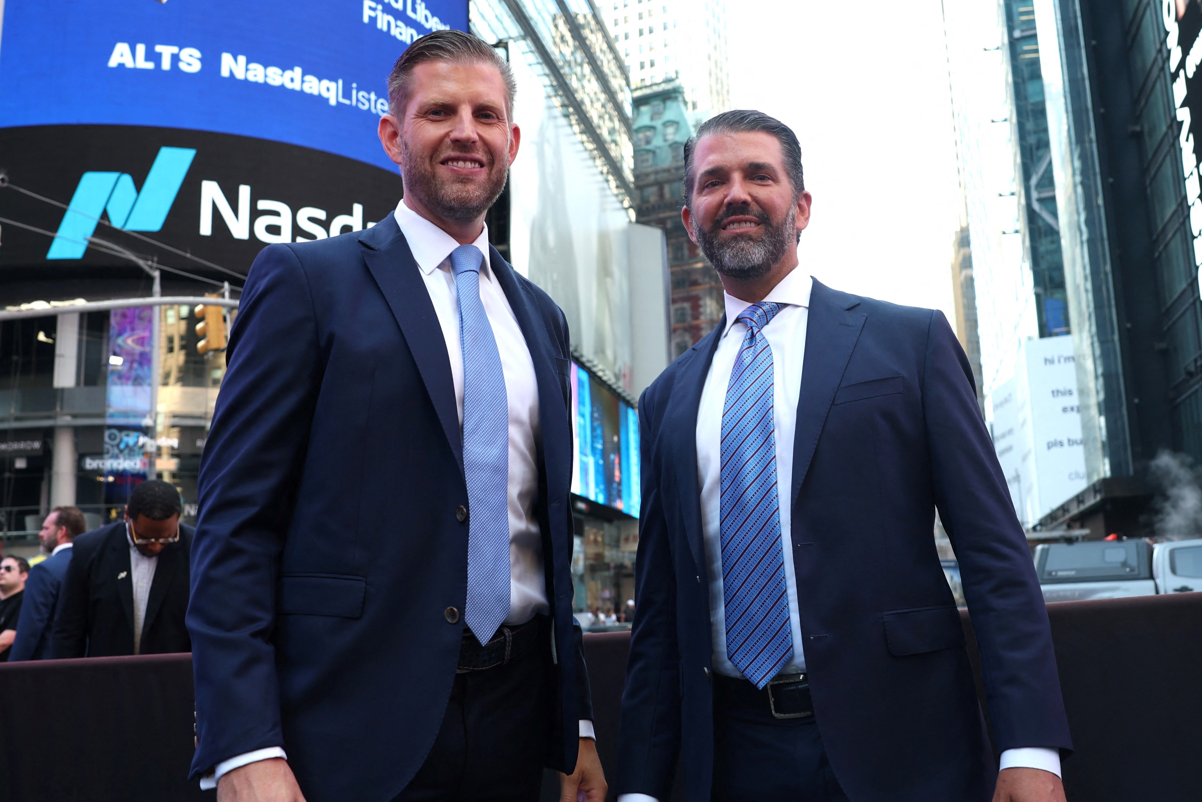 Eric Trump and Donald Trump Jr. pose outside Nasdaq in Times Square.