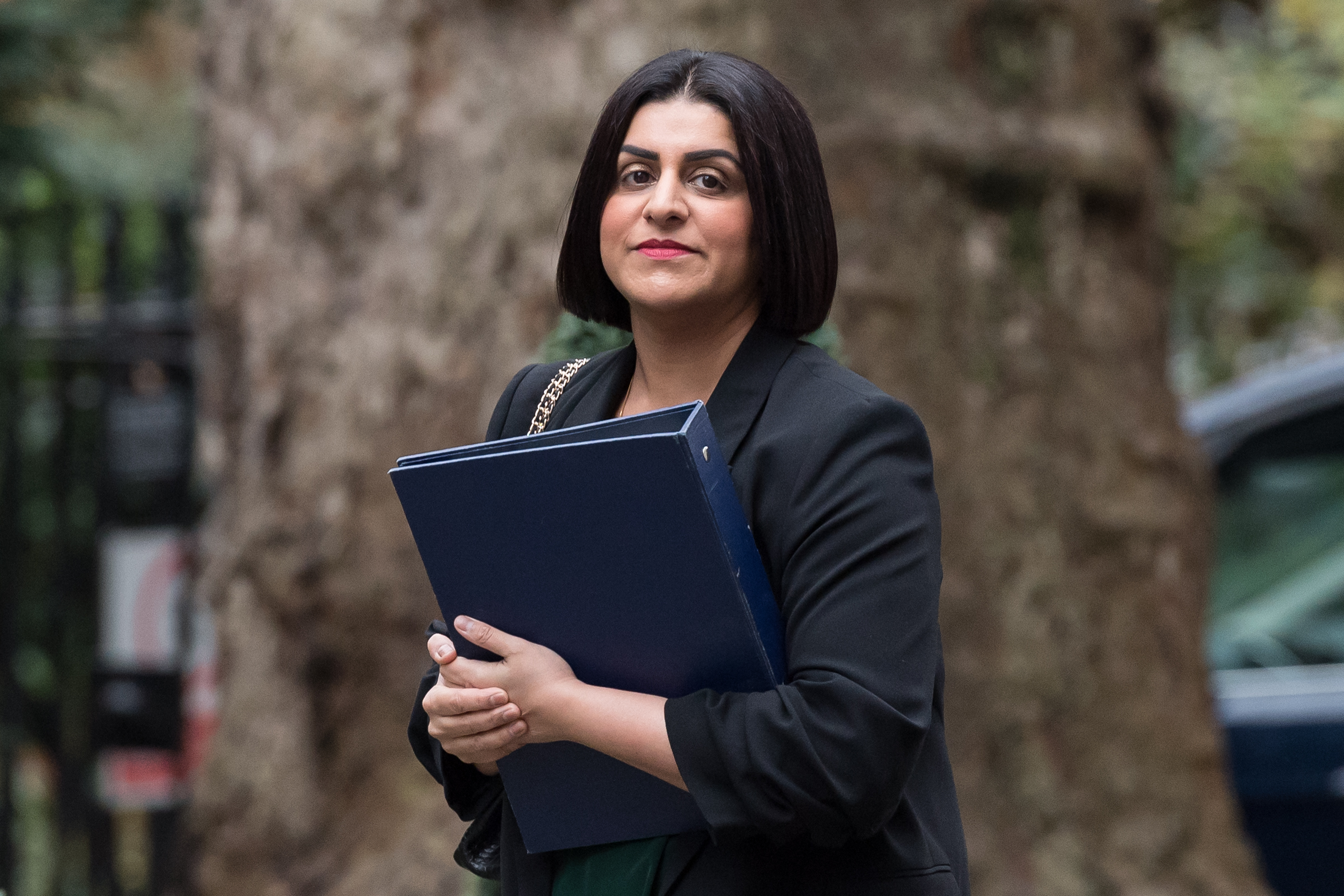 Shabana Mahmood carrying a blue binder in Downing Street.