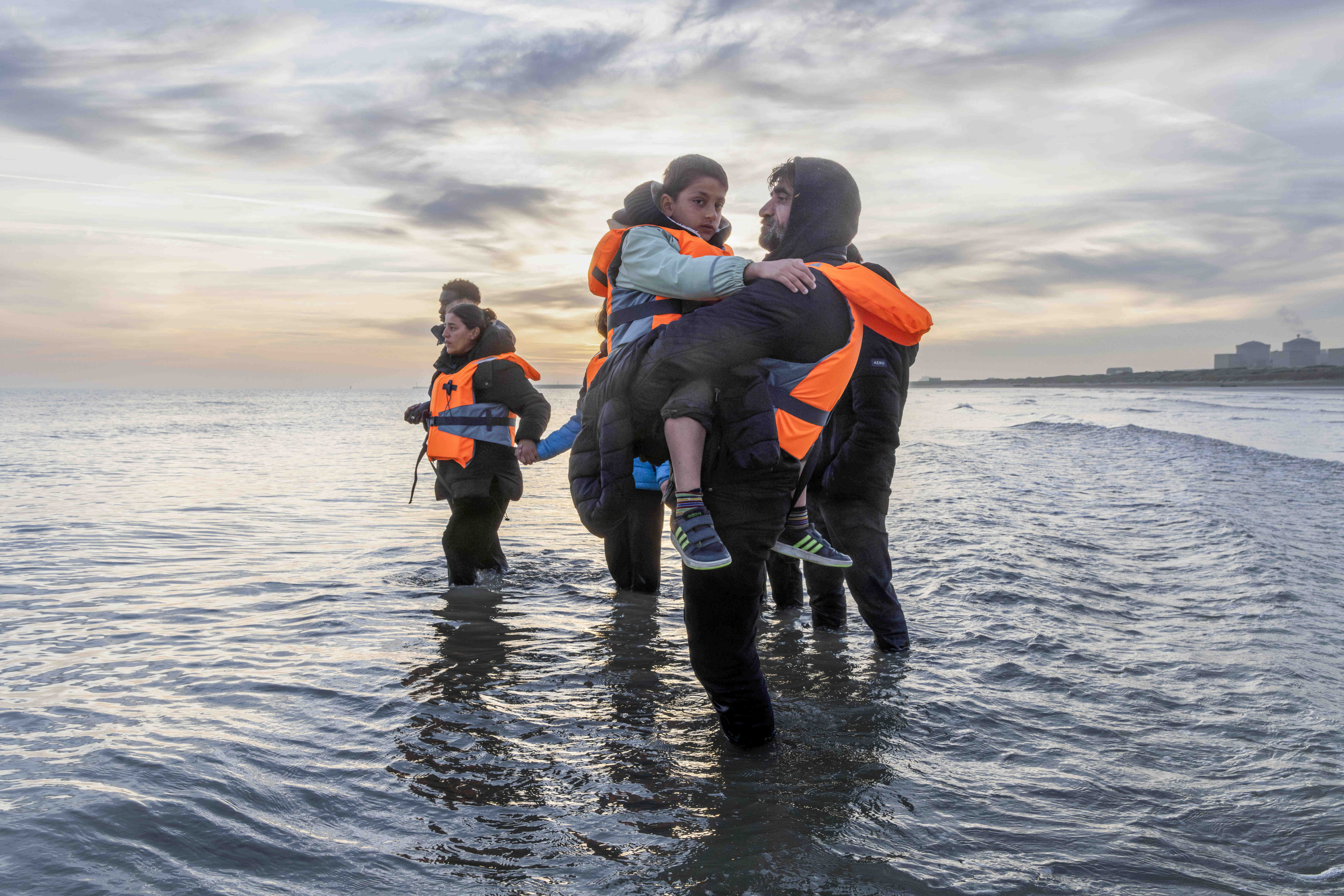 Migrants preparing and getting into boats to cross the English Channel from Gravelines beach near to Dunkirk in northern France.