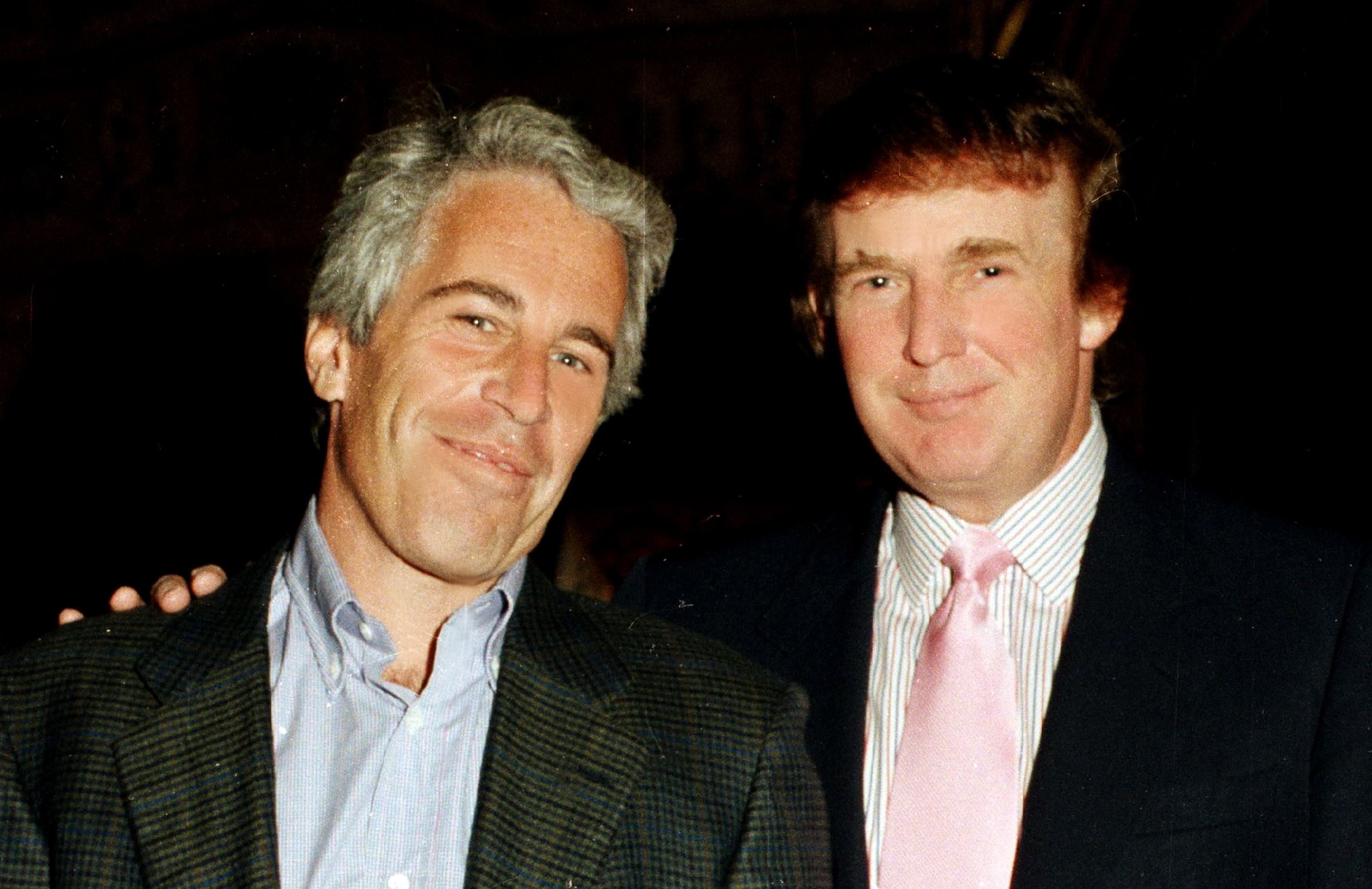 Jeffrey Epstein and Donald Trump pose at the Mar-a-Lago estate.