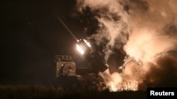 Ukrainian forces fire a BM-21 Grad multiple rocket launch system toward Russian troops in the Donetsk region.