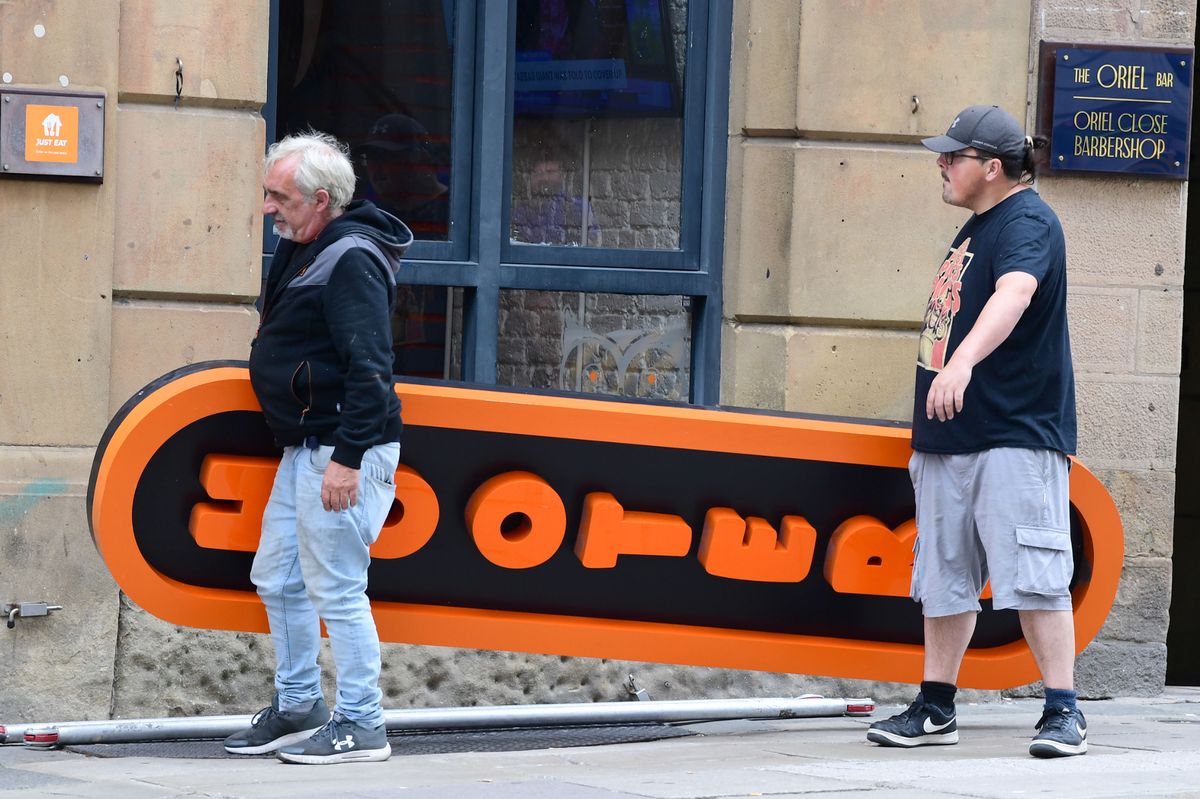 The Hooters sign being taken down on Water Street.(Pic Andrew Teebay).