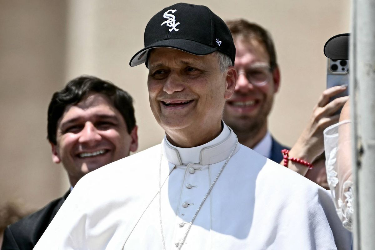 Pope Leo XIV (C) reacts wearing a Chicago White Sox baseball team cap as he meets newly wedded couples during the weekly general audience in St Peter's Square at the Vatican on June 11, 2025. (Photo by Filippo MONTEFORTE / AFP) (Photo by FILIPPO MONTEFORTE/AFP via Getty Images)          