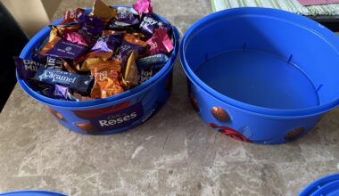 Two tubs of Cadbury Roses fits into one, and yes the lid closed perfectly on it.