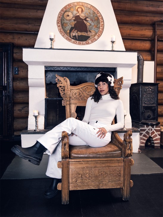 Brazilian-Norwegian singer Charlotte Dos Santos sits on a chair in ski gear