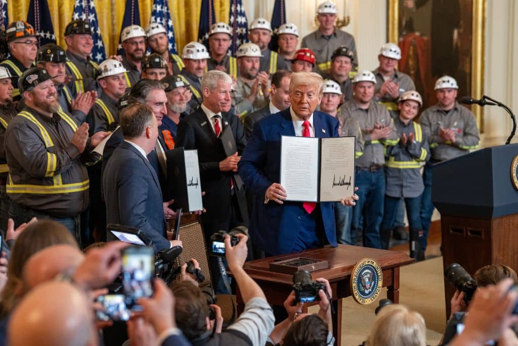 A group of coal miners clap as President Donald Trump signs executive orders on the coal industry on April 8, 2025.