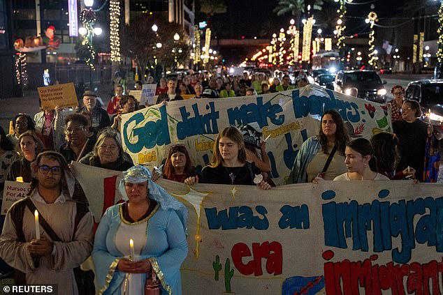 Immigrants rights activists stage a traditional Mexican posada, reenacting Mary and Joseph's search for shelter, to symbolize immigrants seeking refuge from ICE during Catahoula Crunch in New Orleans, Louisiana on December 18, 2025