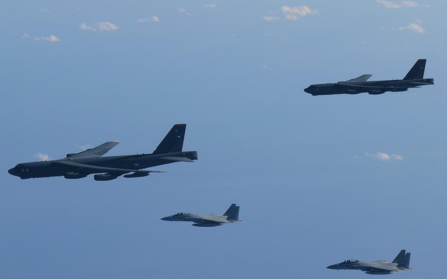 Japanese Self-Defense Force F-15s and U.S. Air Force B-52 Stratofortress bombers fly together.