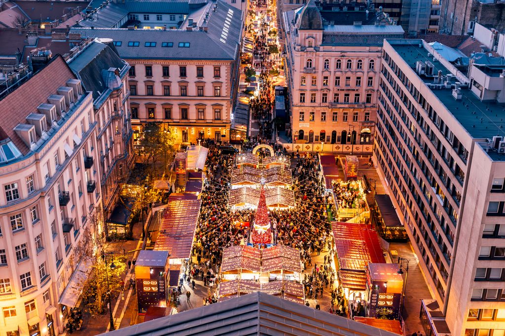 Christmas Market by St. Stephen's Basilica illuminated at dusk, aerial view, Budapest, Hungary