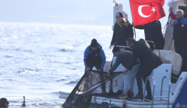 Divers and officials haul a ghost net onto the Fisheries Control boat during a cleanup operation off Kumkale, Canakkale, Türkiye, Dec. 11, 2025. (AA Photo)