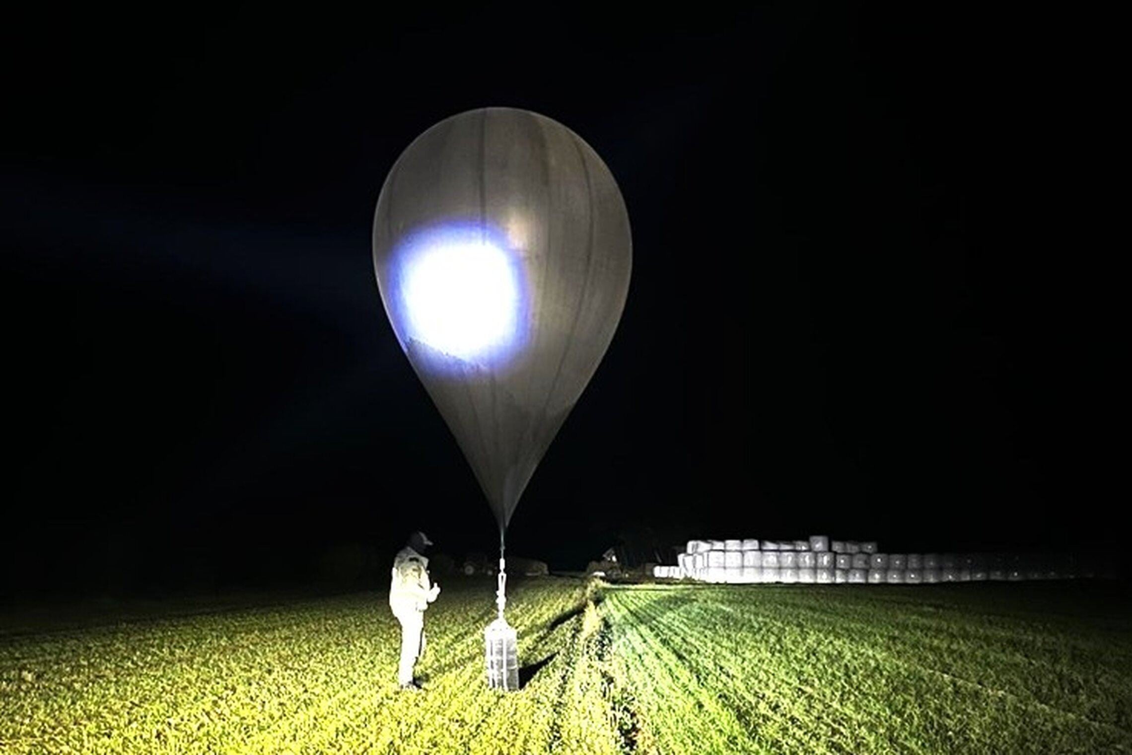 An officer inspects a balloon used to carry cigarettes into Lithuania