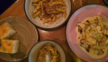 three pasta dishes on a table