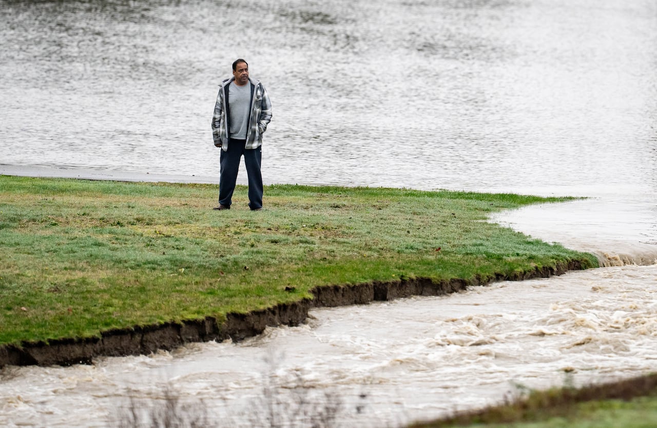 A man watches flood waters