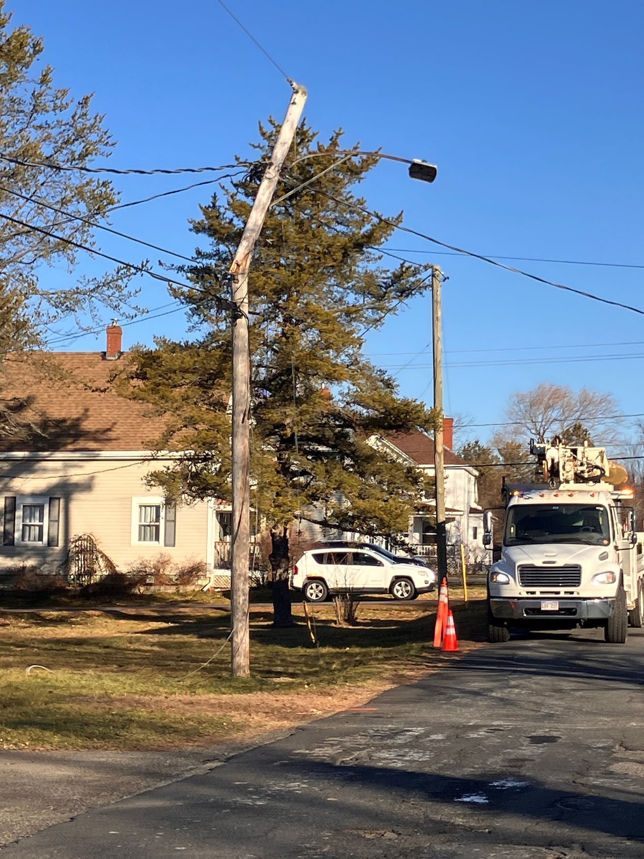A broken power pole along a road. 