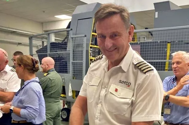 Steve Murray cuts his farewell cake, marking 50 years of service in the Fleet Air Arm