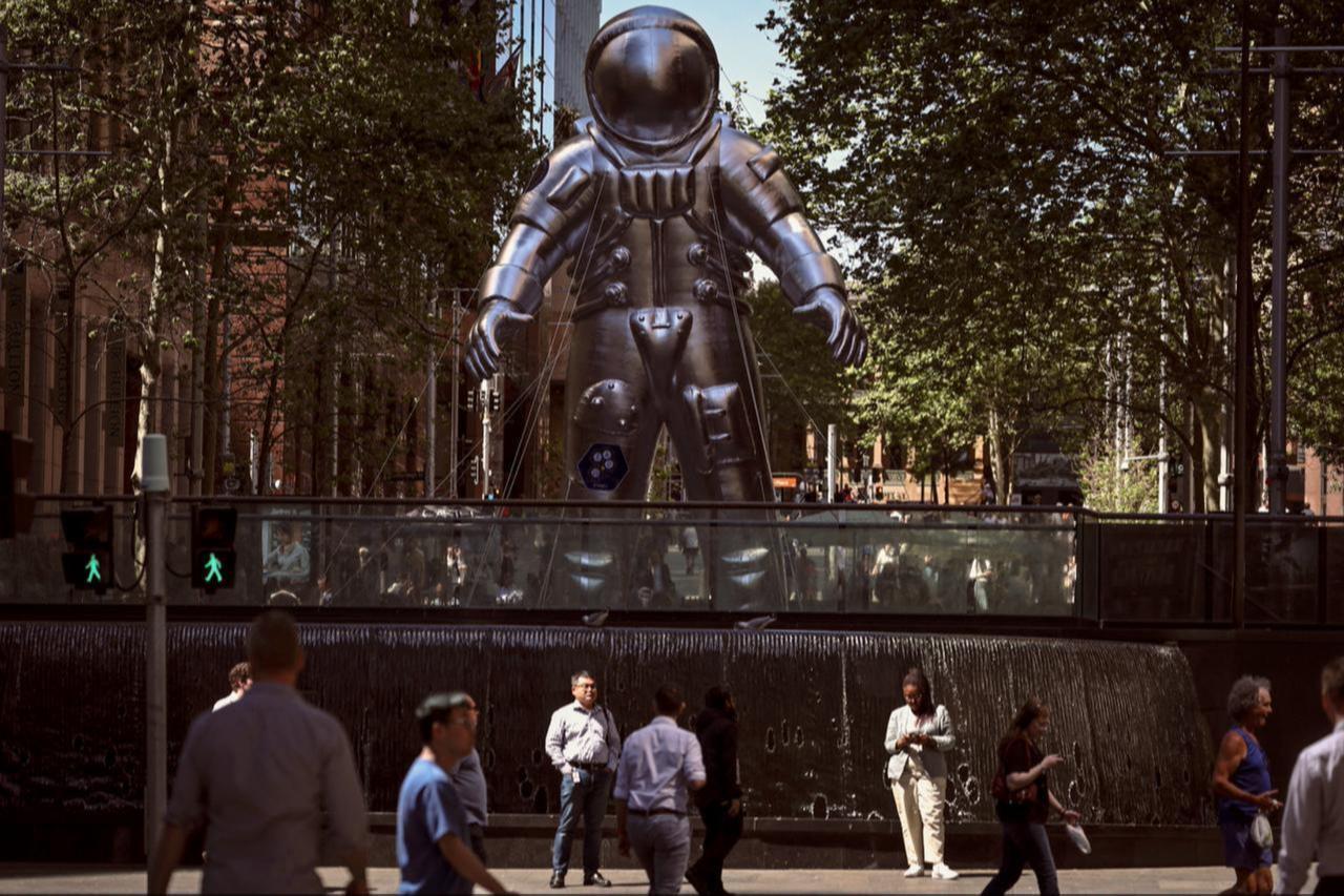 Pedestrians walk past an inflatable astronaut in Martin Place that is part of a promotion for the 76th International Astronautical Congress in Sydney, Australia on Oct. 3, 2025. (AFP Photo)