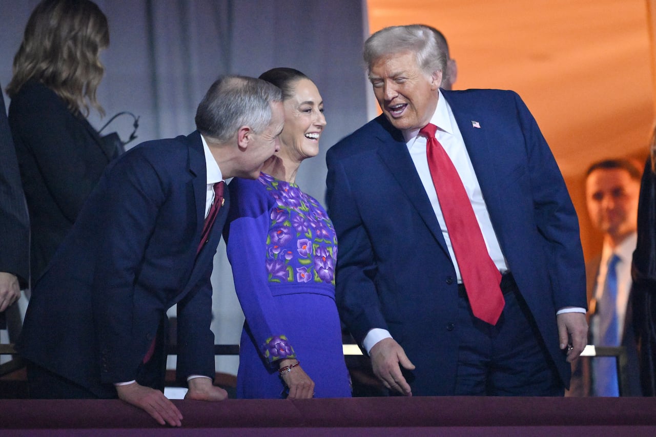 Two men and a woman share a laugh.