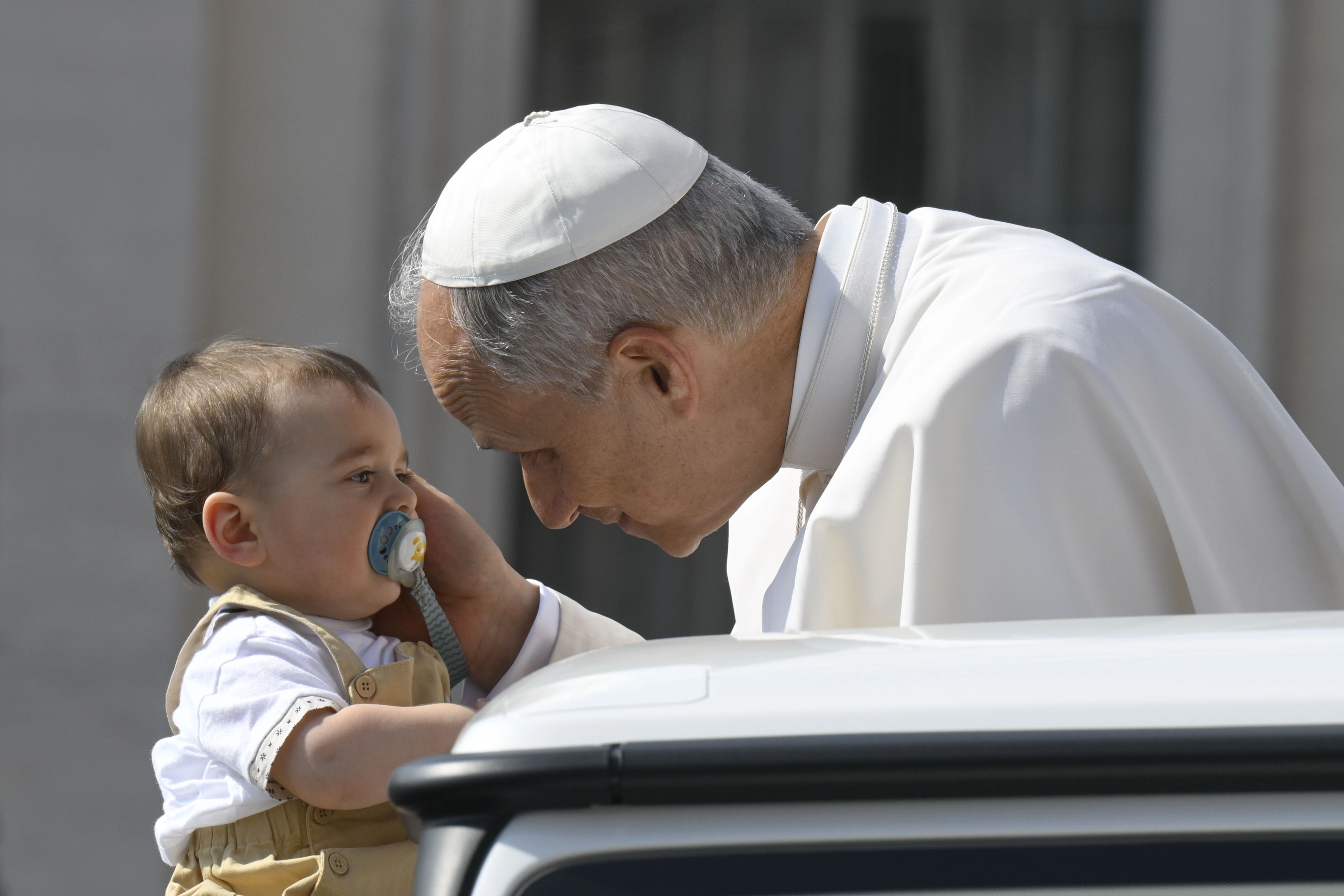 Pope Leo XIV blesses a baby during his general audience  in St. Peter’s Square on June 18, 2025, at the Vatican. Credit: Vatican Media