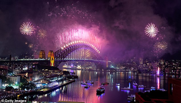 SYDNEY, AUSTRALIA - JANUARY 01: Fireworks light up the sky over the Sydney Harbour Bridge on January 01, 2026 in Sydney, Australia. Thousands turned out to celebrate New Year's Eve in Sydney. (Photo by Sylvain Lefevre/Getty Images)