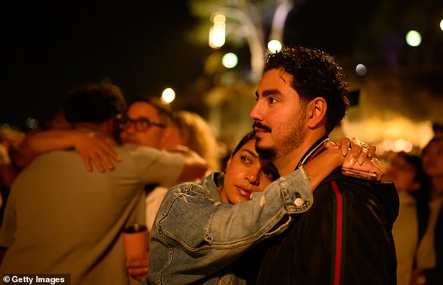 SYDNEY, AUSTRALIA - DECEMBER 31: People enjoy the New Year's Eve firework displays at Opera House on December 31, 2025 in Sydney, Australia. Thousands turned out to celebrate New Year's Eve in Sydney, as the Harbour Bridge lit up with fireworks. (Photo by George Chan/Getty Images)