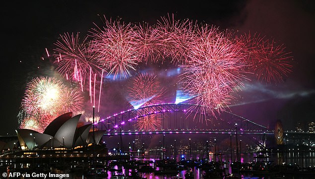 Fireworks light up the midnight sky over Sydney Harbour Bridge and Sydney Opera House during New Year's Day celebrations in Sydney on January 1, 2026. (Photo by Saeed KHAN / AFP via Getty Images)
