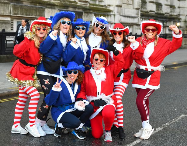 Liverpool Santa Dash competitors in cowboy hats & heart shaped sunglasses.