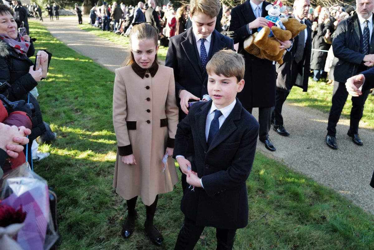 Louis, Charlotte and George getting gifts from the public