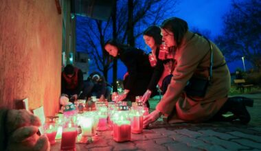 Women light candles at a makeshift memorial outside the Zagreb school where the stabbing happened