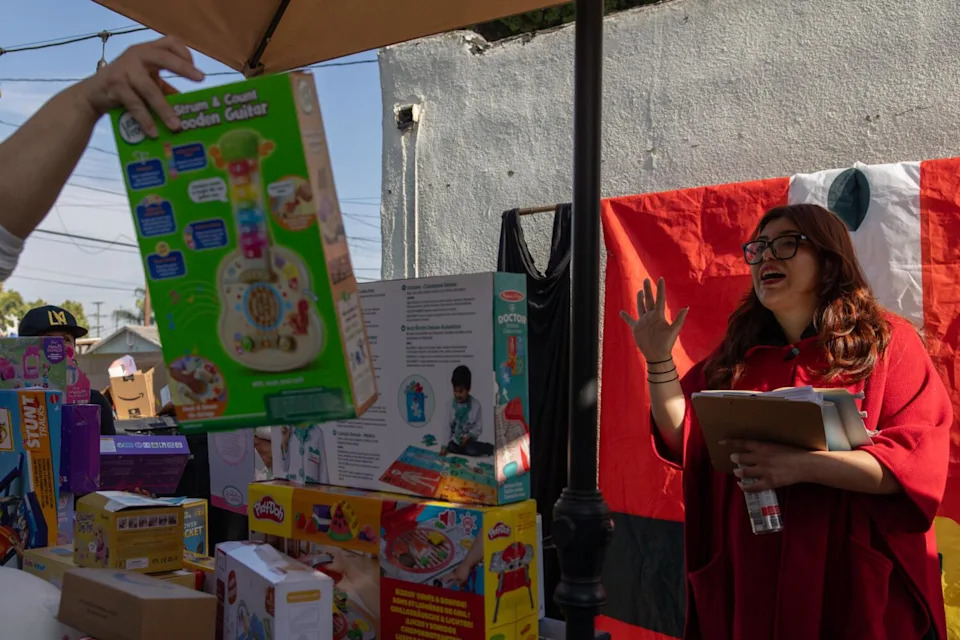 Rosa Vazquez coordinates with volunteers to wrap Christmas gifts for immigrant families.