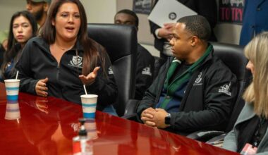 two women speaking at a table