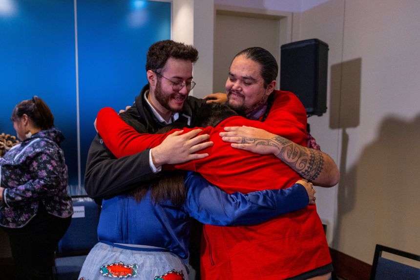 Isaiah Bernard of Potlotek First Nation, Isaiah Andersen from Winnipeg, Katisha Paul of the Lil'wat and Tsartlip Nations and Peyal laceese of the Tsilhqotin Nation embrace after a press conference welcoming 62 Indigenous cultural artifacts on their arrival from the Vatican in Dorval, Quebec, Canada, on December 6, 2025.