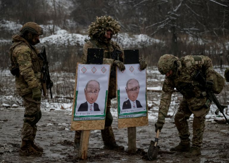 Servicemen of the 13th Operative Purpose Brigade 'Khartiia' of the National Guard of Ukraine prepare targets with images depicting Russian President Vladimir Putin during shooting practice between combat missions, amid Russia's attack on Ukraine, in Kharkiv region, Ukraine December 10, 2025. REUTERS/Sofia Gatilova TPX IMAGES OF THE DAY