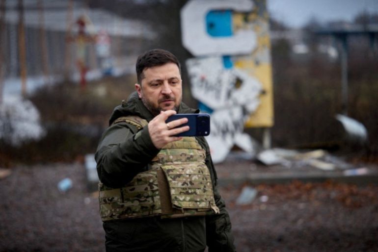 Ukraine's President Volodymyr Zelenskiy self-records a video in front of a sign that reads 'Kupiansk’, amid Russia's attack on Ukraine, in the frontline town of Kupiansk, Kharkiv region, Ukraine December 12, 2025. Ukrainian Presidential Press Service/Handout via REUTERS ATTENTION EDITORS - THIS IMAGE HAS BEEN SUPPLIED BY A THIRD PARTY.