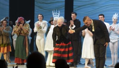 Queen Margrethe of Denmark takes a bow with the cast of this year