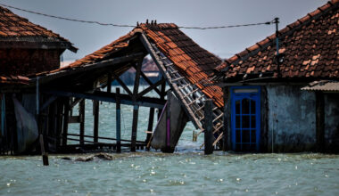 This photo taken on July 30, 2025, shows abandoned and partially submerged houses due to land loss from climate change at Bedono village in Demak, Central Java.