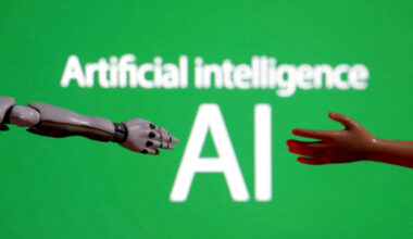 Words reading &ldquo;Artificial intelligence AI&ldquo;, miniature of robot and toy hand are pictured in this illustration created on Dec. 14, 2023.