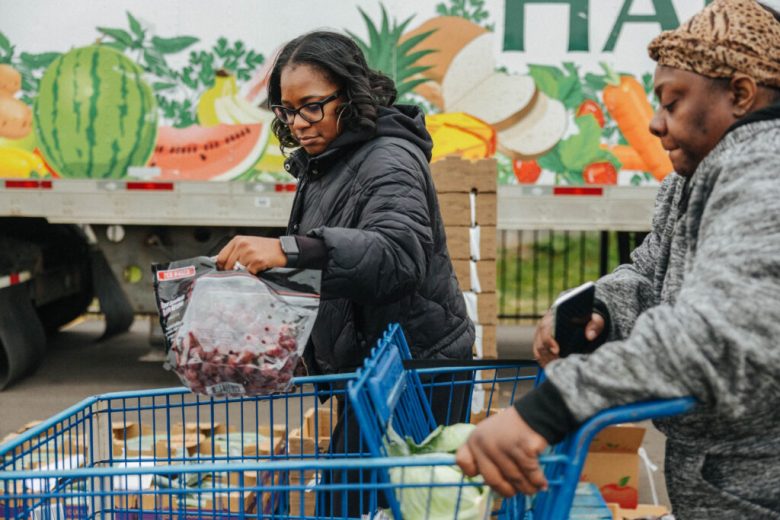 Volunteers distribute food at a mobile pantry at Jesus Tabernacle of Deliverance Ministries on Detroit's east side.