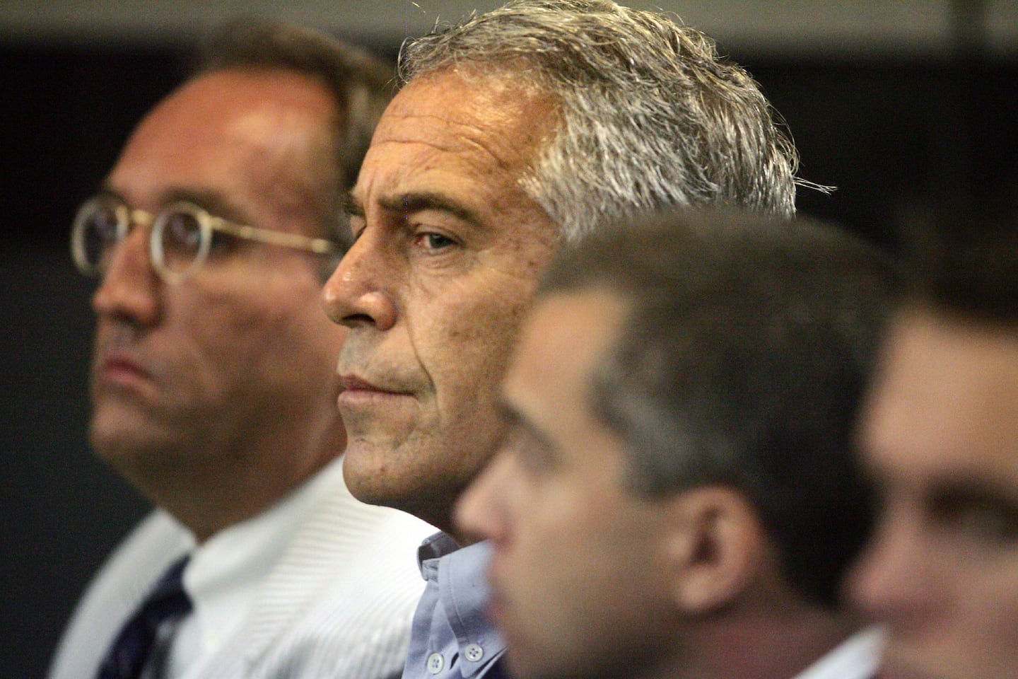 Jeffrey Epstein, center.